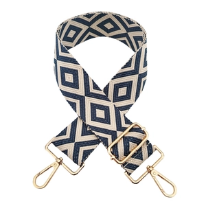 Detail view of beige and blue geometric diamond weave strap with gold metal hooks