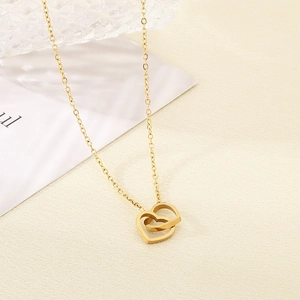 Detail of 18K gold-plated double interlocking heart pendant on a fine O-chain necklace