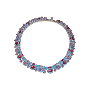 Collier vintage avec pierres roses et rouges entourées de cristaux bleus sur argent