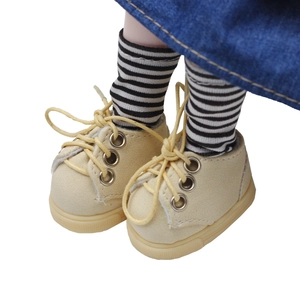Close-up of beige canvas sneakers and striped socks for 20cm cotton plush doll