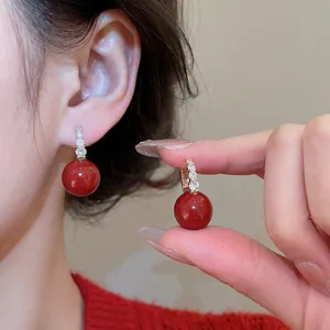 Elegant red zircon round earrings with sparkling crystal accents worn by model