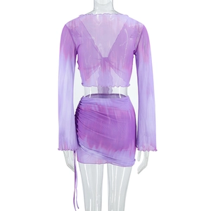 Detail of purple tie-dye mesh set featuring lace-up back top and ruched mini skirt