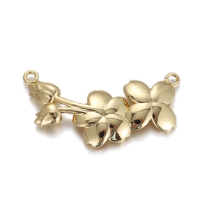 Detailed macro view of golden flower charms for DIY jewelry with dual connectors
