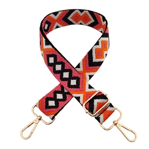 Detail of bohemian geometric diamond jacquard strap with gold-tone swivel lobster clasps