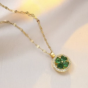 Golden titanium necklace featuring a rotating green zircon flower pendant on beige silk