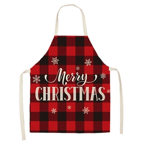 Detail of red and black plaid Christmas apron with Merry Christmas print and snowflakes