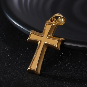 Macro shot of a polished gold stainless steel cross pendant with beveled edges