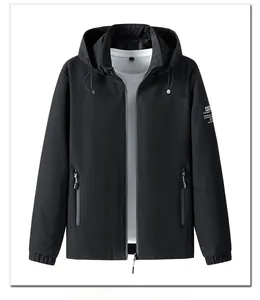 Detail of a black hooded jacket featuring a zip closure and white sleeve lettering