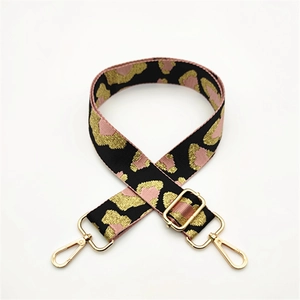 Adjustable leopard print bag strap with gold metal hardware and chic woven design