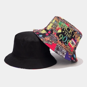 Detail of reversible bucket hats with retro 90s graffiti print and solid black cotton