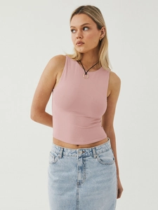 Detail of pink slim fit sleeveless tank top paired with light blue denim skirt