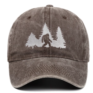 Close-up of high-density Bigfoot and pine trees embroidery on washed cotton baseball cap