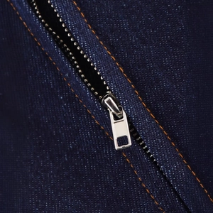 Sleeveless denim dress in dark blue with orange contrast stitching and metal zipper
