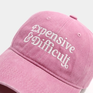 Detailed close-up of white 3D embroidery Expensive & Difficult on pink cotton baseball cap