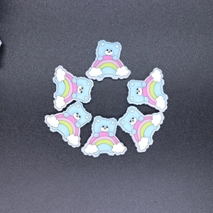 Detail of blue cartoon bear on rainbow resin charms for DIY phone cases and hair clips