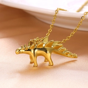 Polished gold stegosaurus dinosaur pendant necklace with a fine chain for women