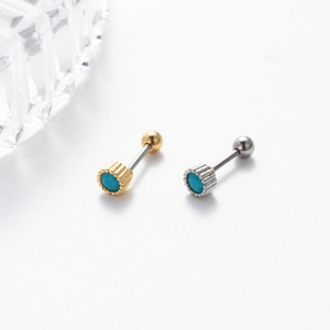 Detail of blue turquoise stone earrings with gold and silver threaded ball backings