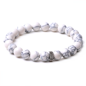 Detail of white marble turquoise beads with silver diamond-textured metal spacer on elastic cord