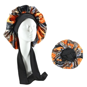 Close-up of leopard chain print satin hair bonnet with wide elastic black tie bands