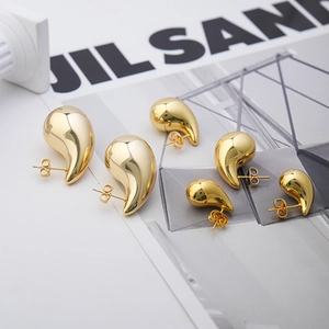 Detailed set of three gold water-drop earrings in various sizes with high-polished finish