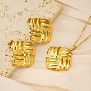 Detailed view of golden woven knot jewelry set featuring earrings and pendant necklace