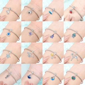 Ocean series silver charms with dolphin and turtle designs on a snake chain bracelet