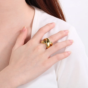 Detail of 18k gold cross ring showing the polished thick double band design on finger