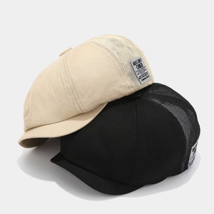 Breathable mesh newsboy cap in beige and black with vintage woven side label