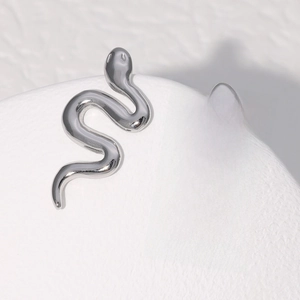 Minimalist silver snake earrings in stainless steel with a sleek metallic finish