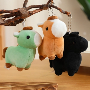 Three colorful plush pony keychains hanging on wooden branches for backpack decoration