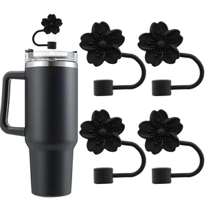 Detail of black flower silicone straw covers and matching tumbler with dustproof caps