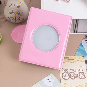 Pink photo album with circular heart cutout for collecting idol photocards on wood
