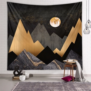 Detail of modern abstract mountain tapestry with gold marble pattern on white brick wall