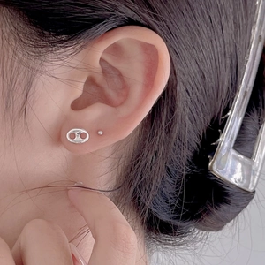 Detail of 925 sterling silver stud earrings featuring coffee bean and bead designs