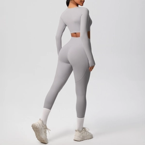 Close-up of light grey two-piece yoga set showing high-waisted fit and breathable fabric