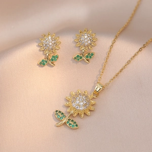 Elegant gold sunflower jewelry set with zircon necklace and earrings on silk background