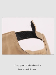 Detail of adjustable velcro strap on khaki cotton baseball cap for kids and toddlers