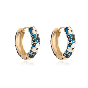 Detail of 18K gold plated hoop earrings with blue enamel and white floral pattern