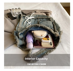 Macro shot showing large interior capacity of washed denim bag with vintage frayed edges