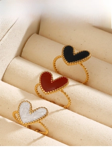Three stackable 18K gold plated heart rings with black red and white enamel details