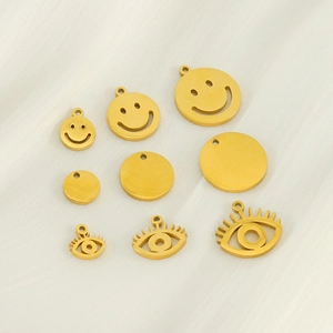 Detailed view of 18K gold stainless steel pendants in smiley, circle and eye designs