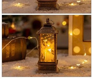 Bronze Christmas lantern with angel design and warm LED light on a snowy surface