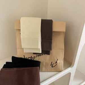 Close-up of ribbed texture and elastic cuffs on solid color combed cotton long socks