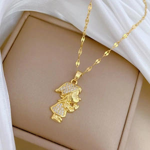 Macro shot of a gold necklace featuring a standing girl pendant with zircon stones