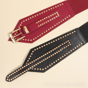 Detail view of studded elastic waist belts in burgundy and black with gold metal hardware