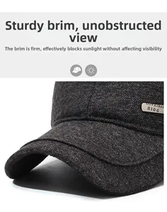 Detailed macro view of dark grey wool texture and metal brand plate on earflap cap