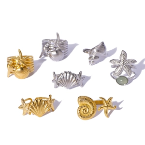 Set of 7 ocean-themed stainless steel rings featuring starfish and shell designs in gold and silver