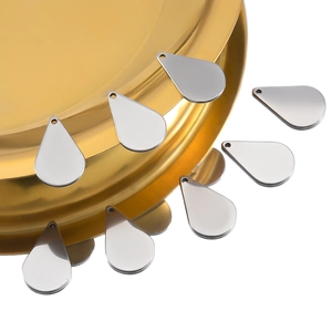 Polished silver teardrop stainless steel pendants arranged for DIY jewelry making