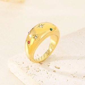 Detail of gold dome ring with colorful star-set zircons on natural stone base