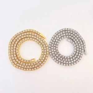 Detail shot of gold and silver tennis chains with shimmering diamond-encrusted links